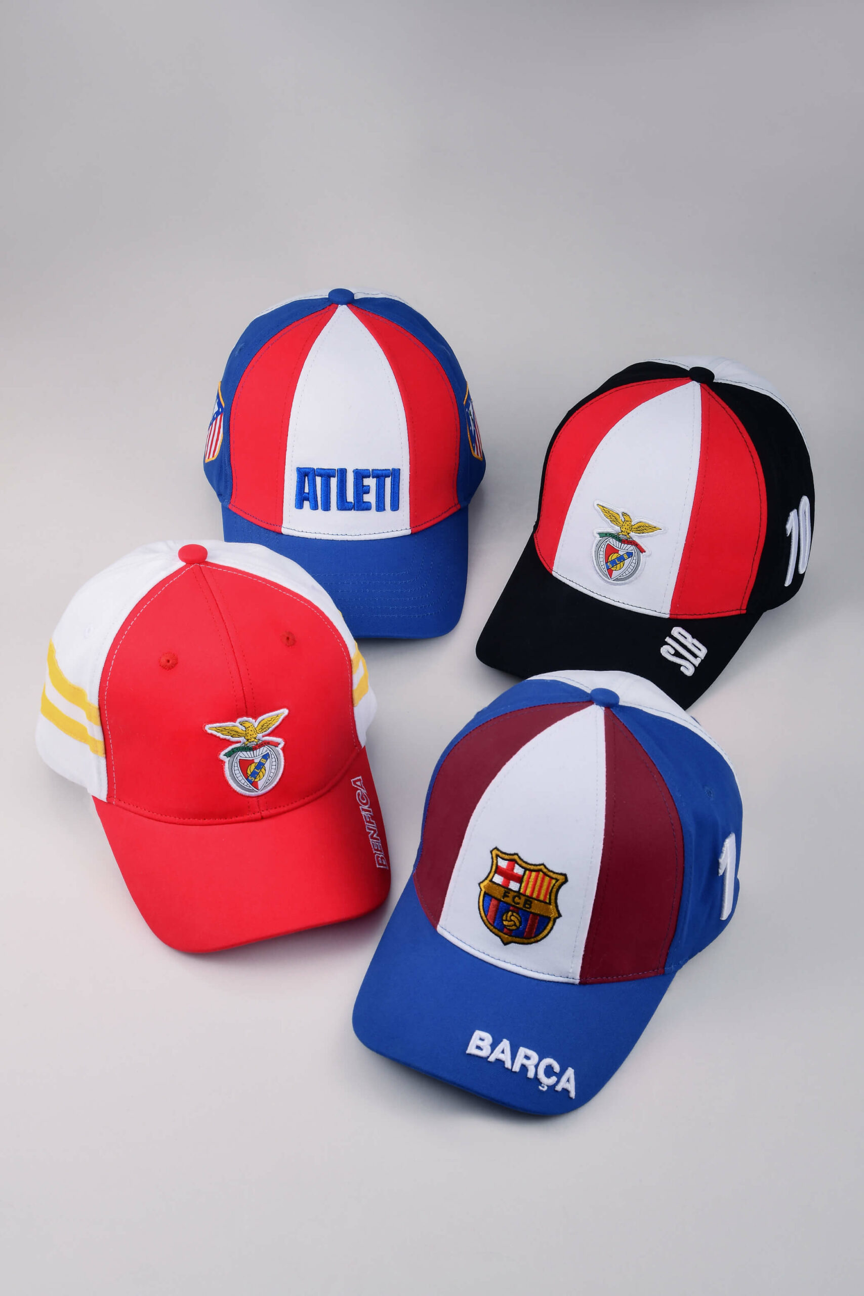 Group of FC Barcelona fan friends celebrating in a bar with official Ball On Top caps and wands